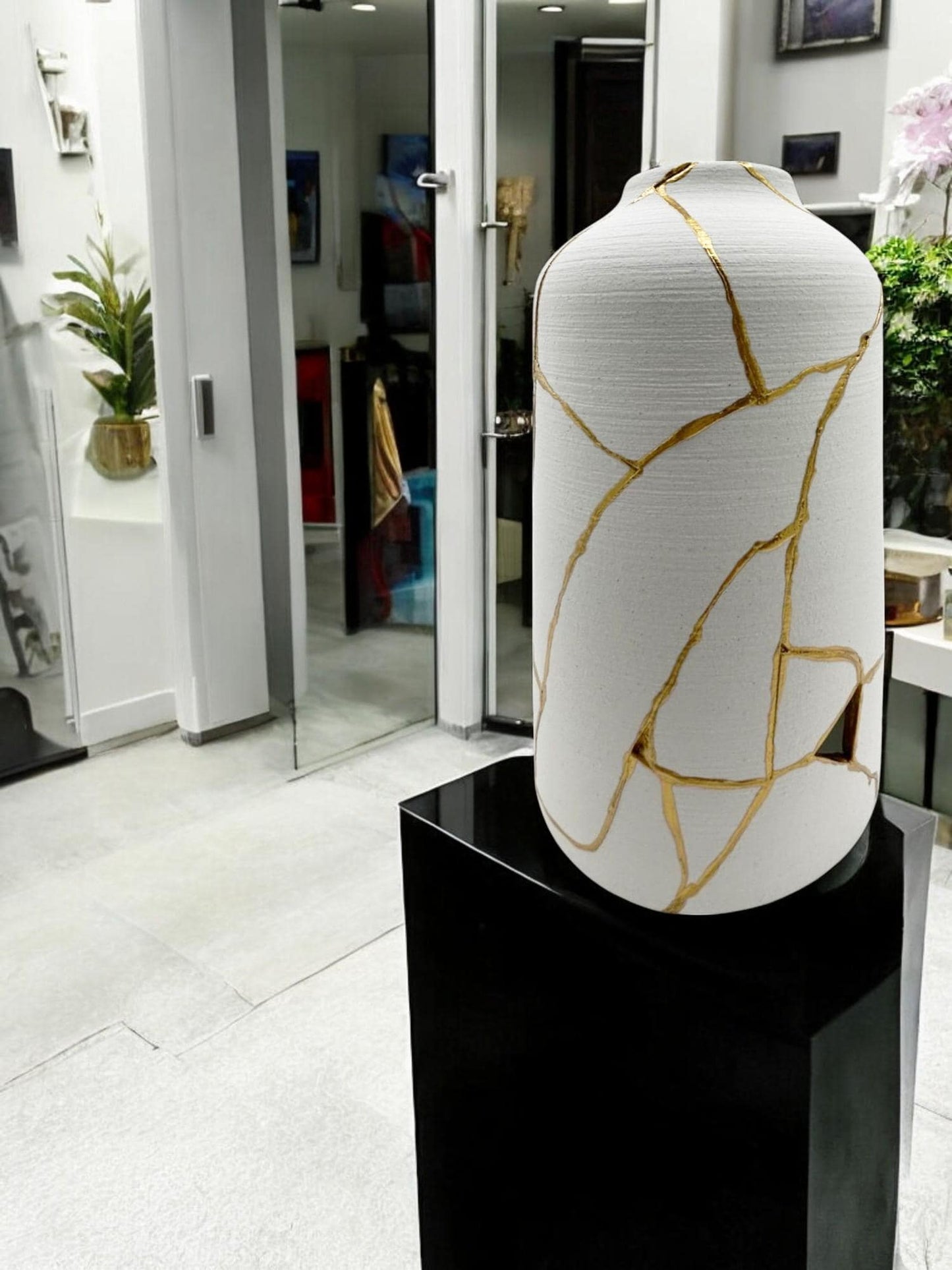 buy online luxury, bestseller, handmade, one of a kind, modern kintsugi japanese pottery art gift decorative cylinder vase for dried flowers in white with rough brushed horizontal texture and gold paint along break lines for sale