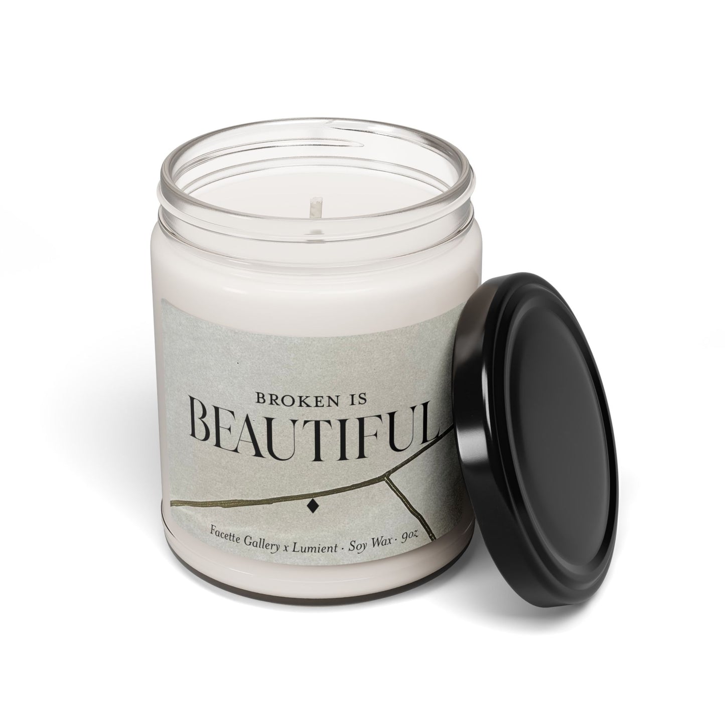 9oz beige soy candle in clear glass jar with black lid and "Broken Is Beautiful" Kintsugi-inspired label design