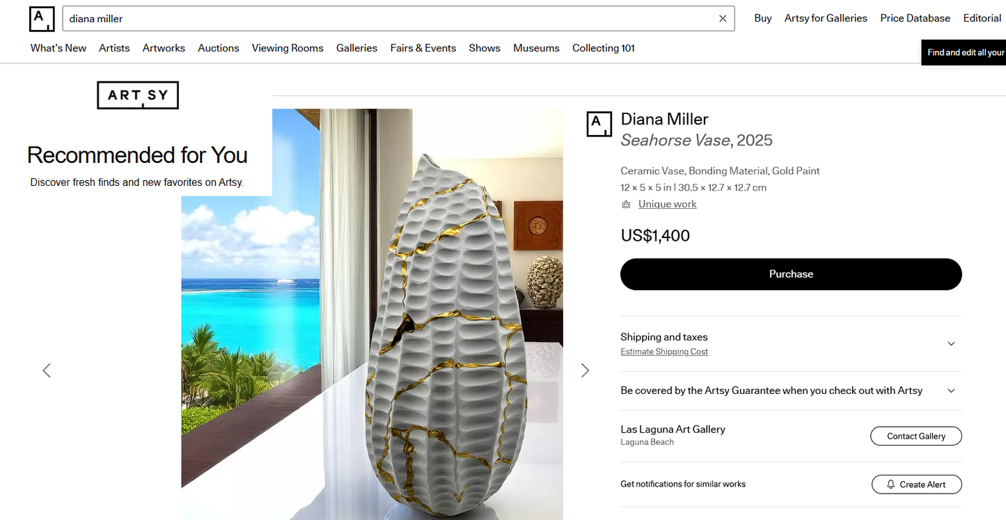 Matte ceramic Seahorse Vase with gold paint details, 12 inches tall, displayed on wooden table by window with ocean view.