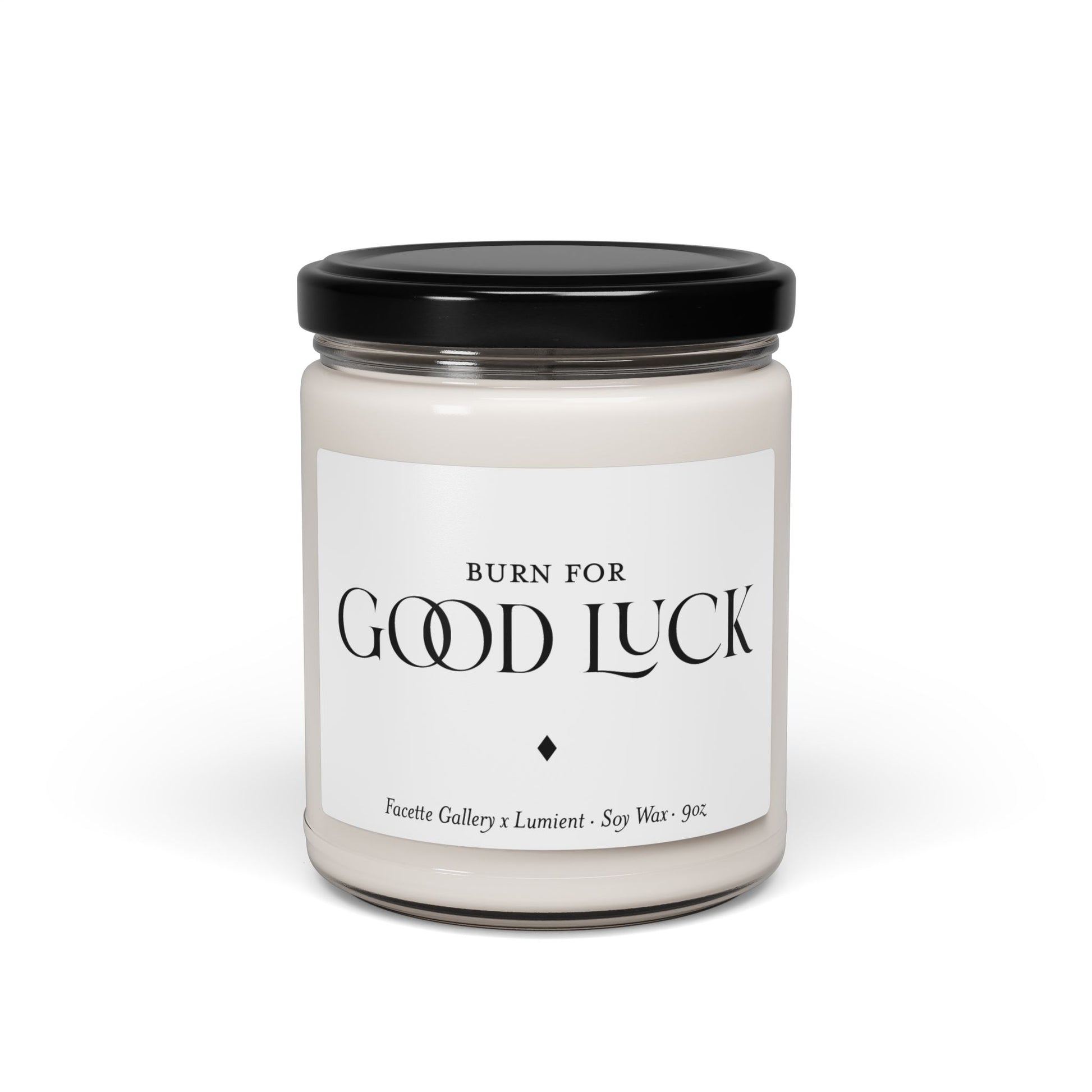 White soy wax candle in 9oz clear glass jar with black lid and "Good Luck" label in black text