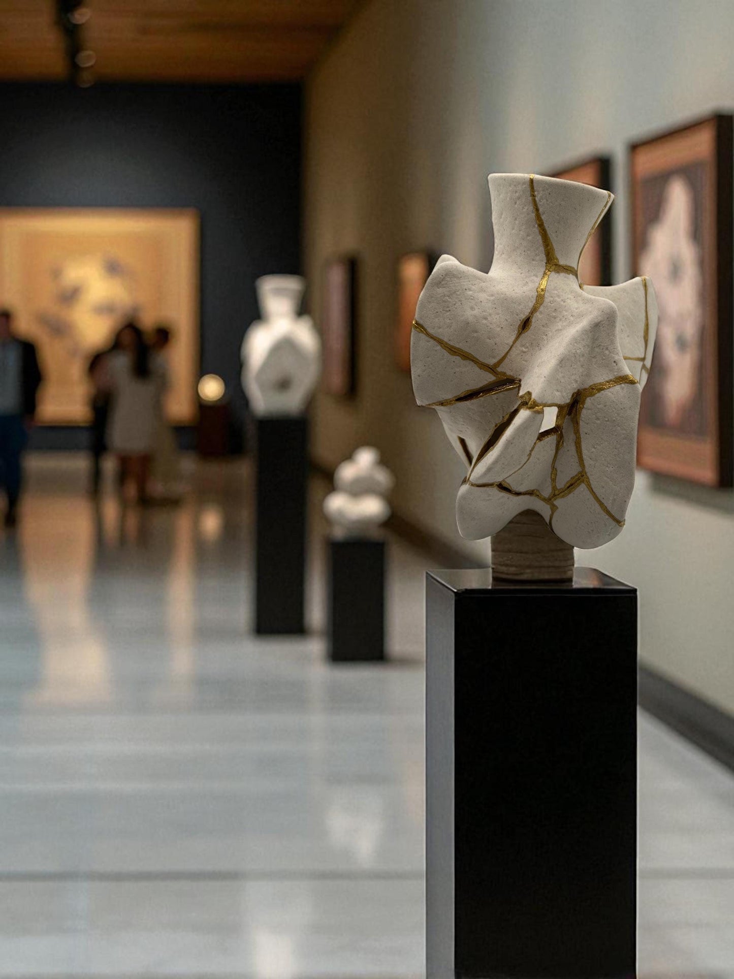 White modern kintsugi vase with gold repaired cracks displayed on black pedestal in art gallery hallway.