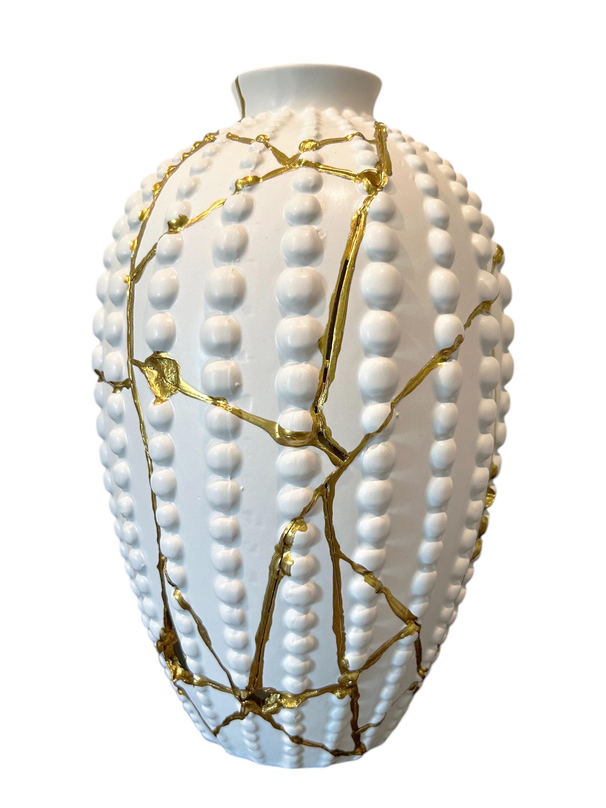 White modern kintsugi sea urchin vase with hand-painted gold repairs and textured ceramic surface, 12.5 inches tall.