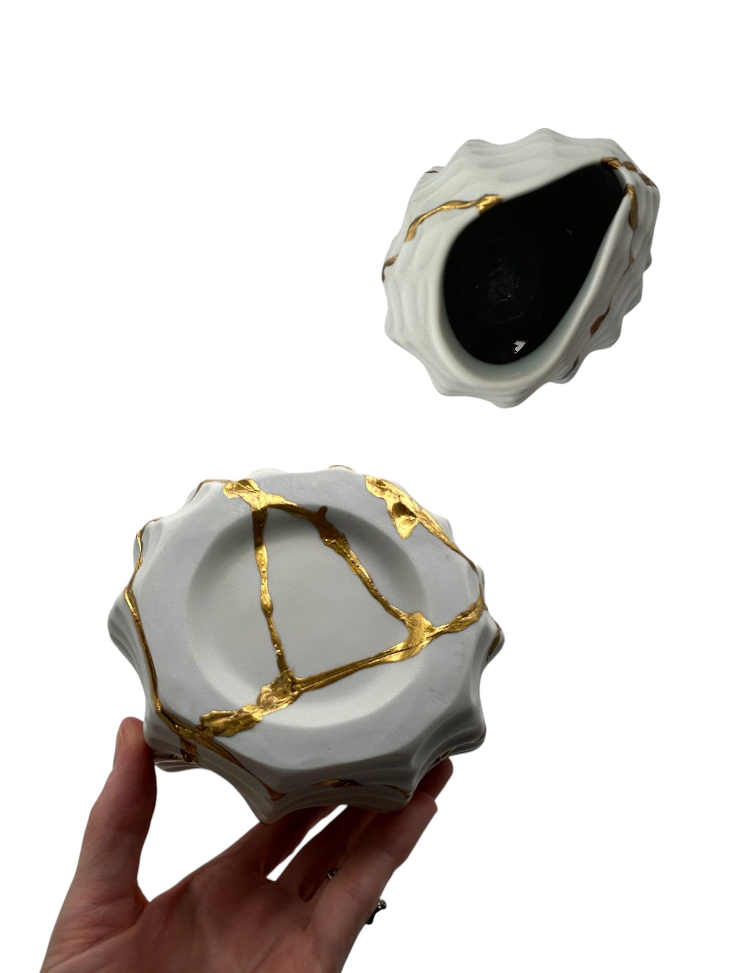 Handcrafted modern kintsugi seahorse vase with gold repairs on white Japanese pottery, 12in tall, held in hand.