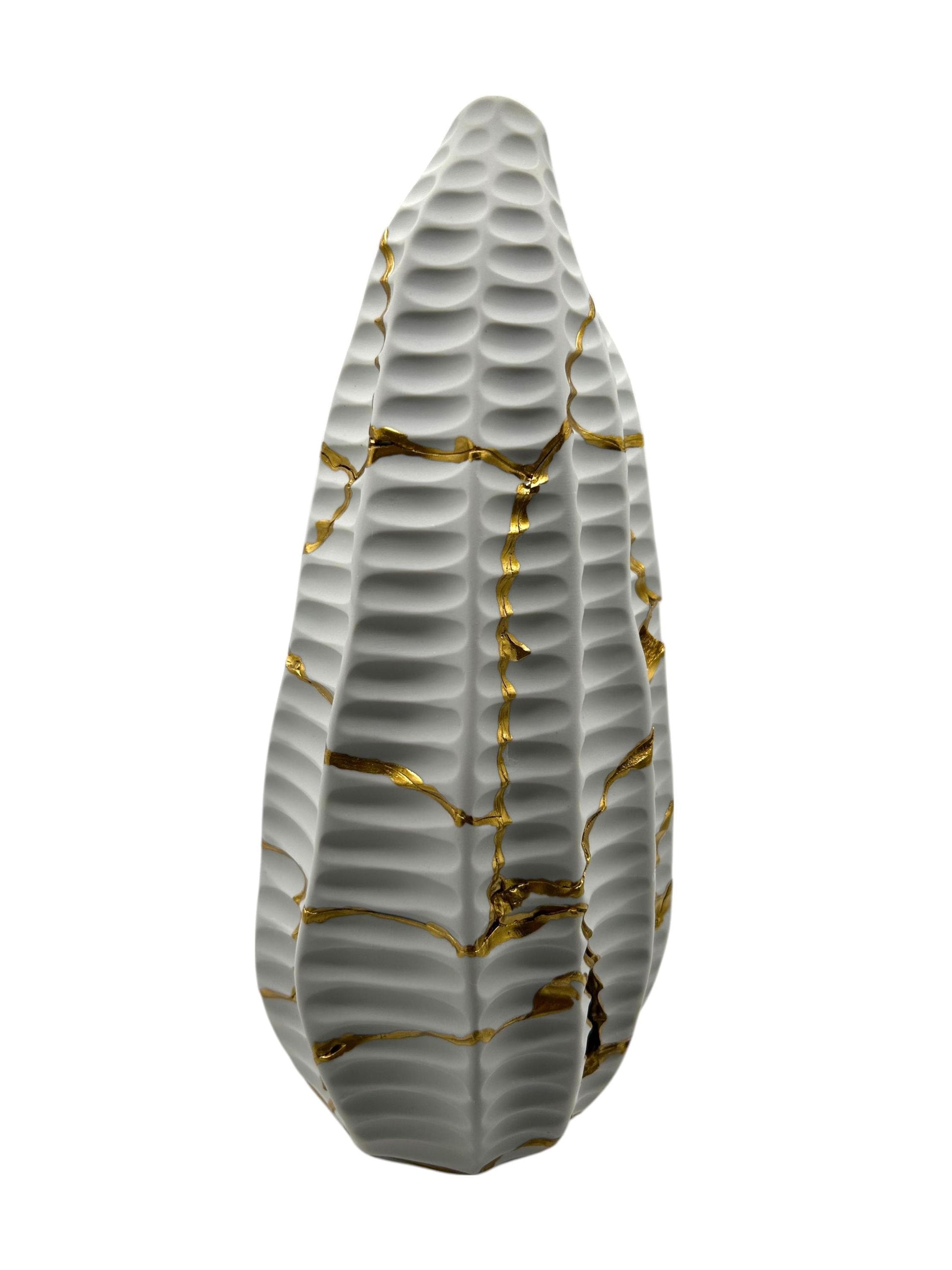 White handcrafted pottery vase with textured surface and gold kintsugi repair lines on a plain white background