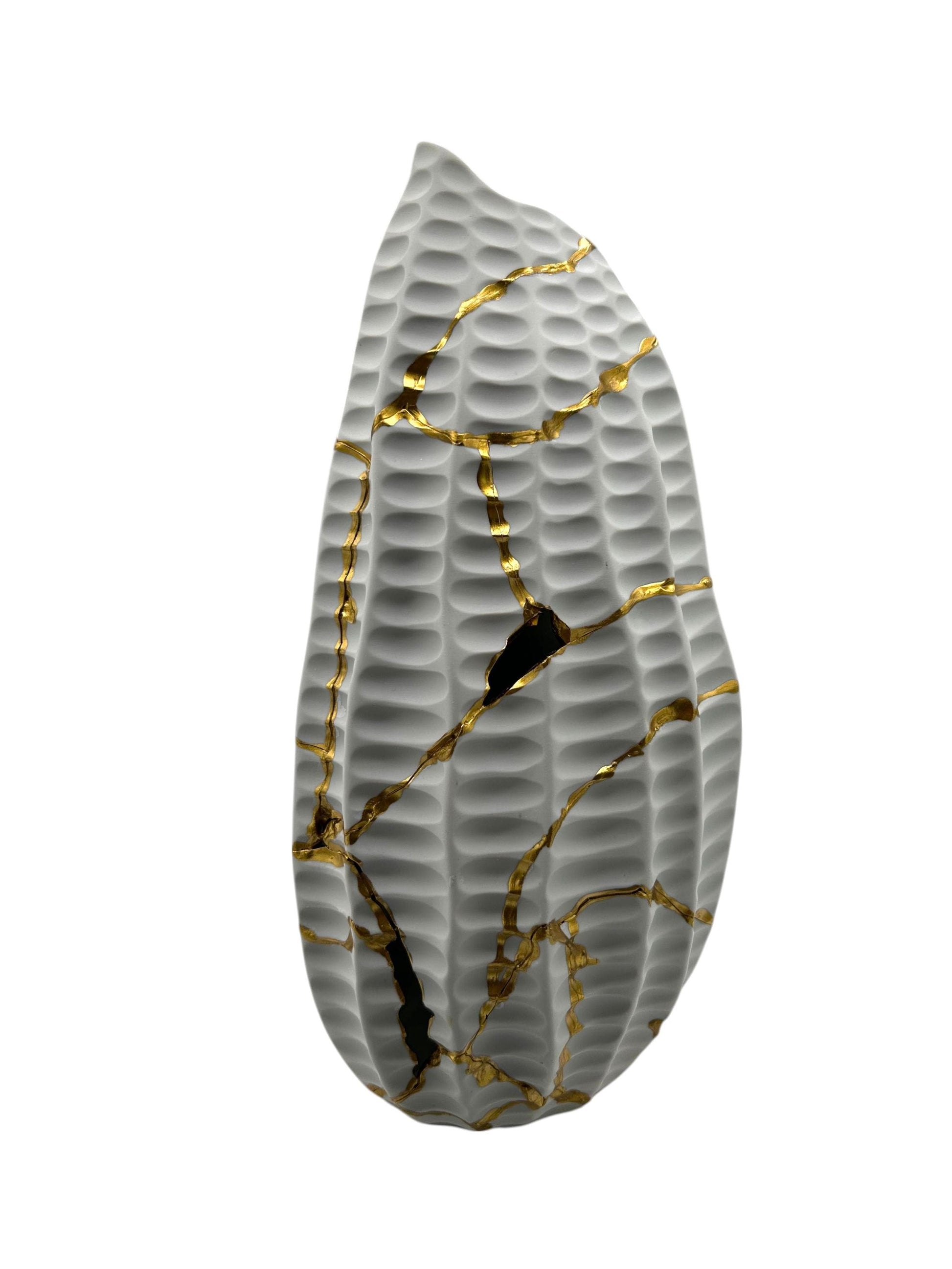 Modern Kintsugi seahorse vase with textured gray surface and hand-painted gold repair lines on white background