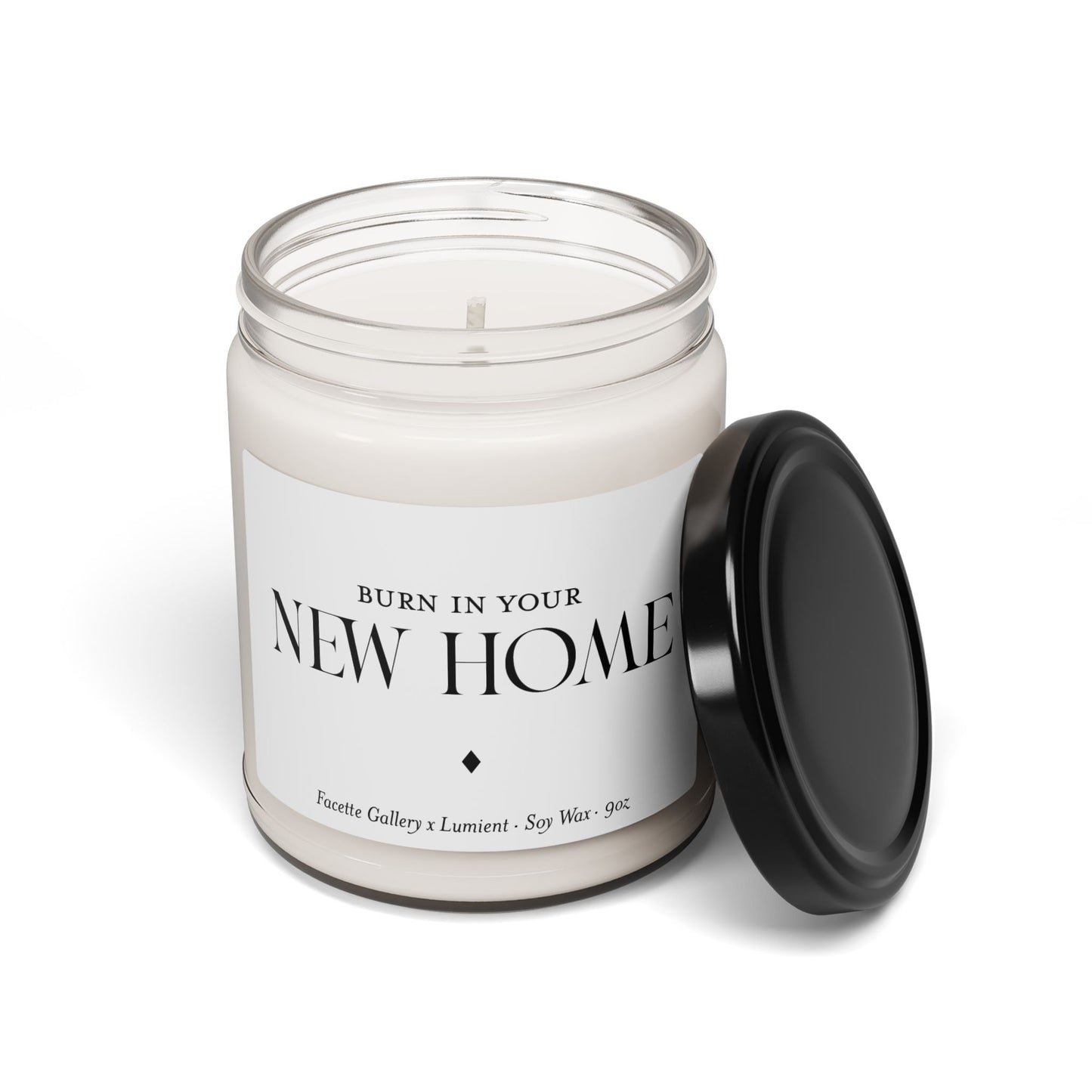 9oz white soy wax candle in clear glass jar with black lid and "New Home" label, eco-friendly and hand poured design