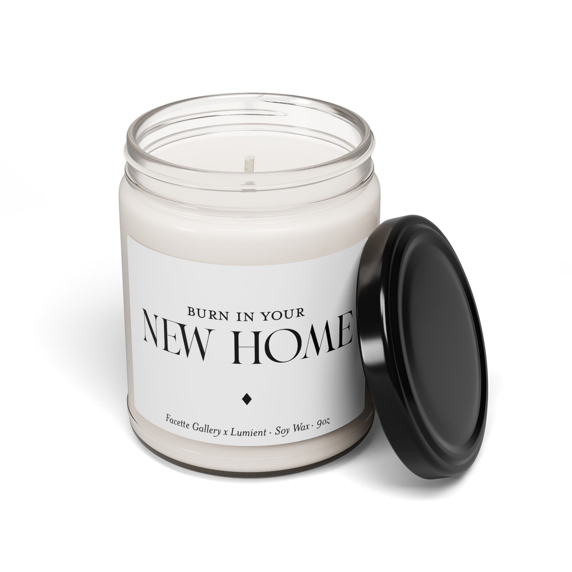 9oz white soy wax candle in clear glass jar with black lid and "New Home" label, eco-friendly and hand poured design