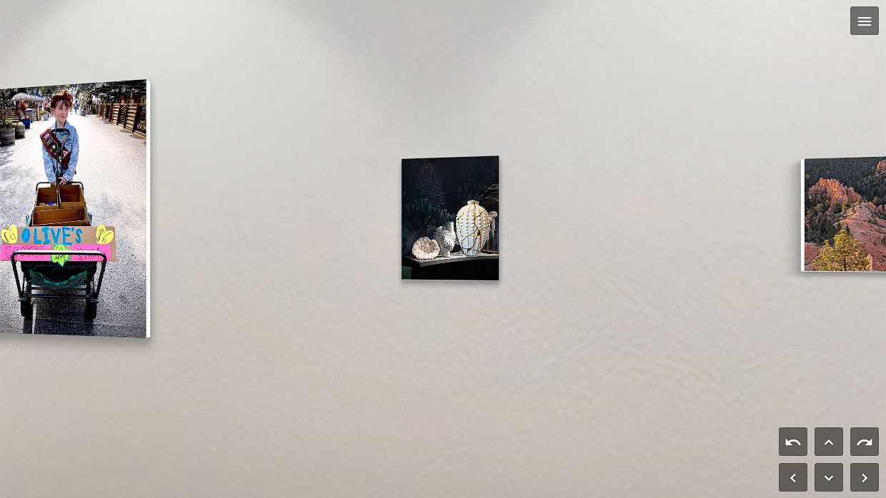 Three framed pictures on a wall with a neutral background