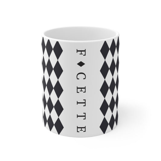 White ceramic mug with black diamond pattern and vertical FACETTE logo on a plain white background